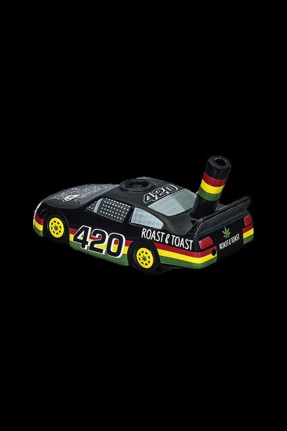 A black toaster with "420" and cannabis leaf graphics, featuring a pipe-like extension and Rastafarian colors.