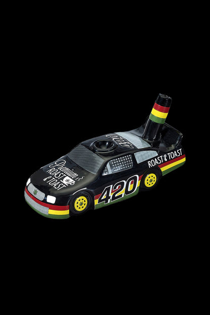 Miniature toy car designed as a cannabis grinder with “420” and “Roast & Toast” branding, set against a black background.