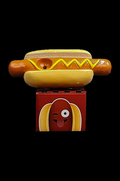 Hot dog shaped cannabis packaging box with a rolled joint resting on top.