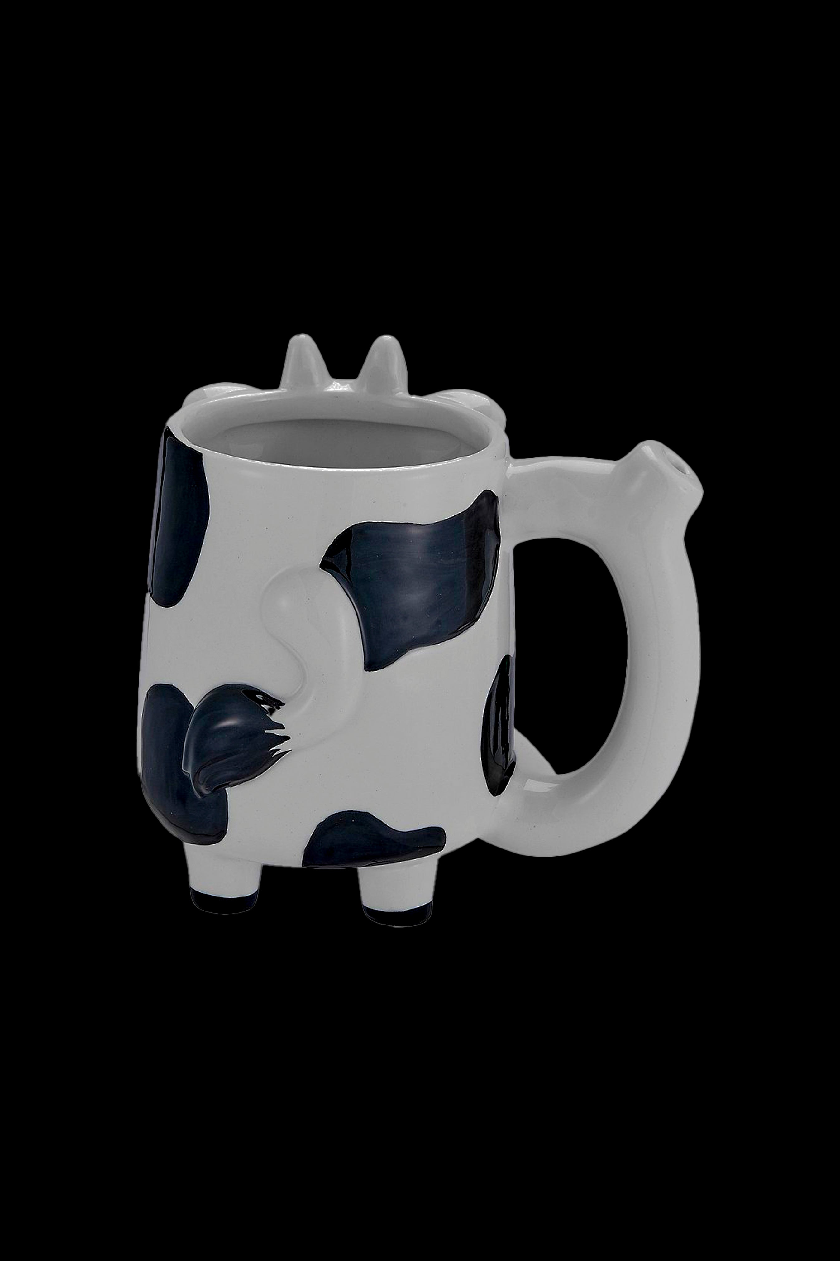 White ceramic skull-shaped smoking piece with black detailing, isolated on a black background.