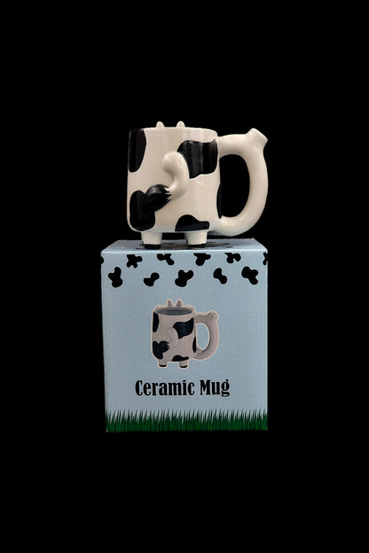 Cow-shaped ceramic mug in box, cannabis accessory.