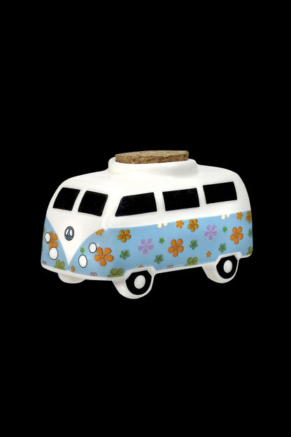 Ceramic VW-style van with a cork lid, decorated with colorful floral patterns, likely used as a storage container for cannabis.
