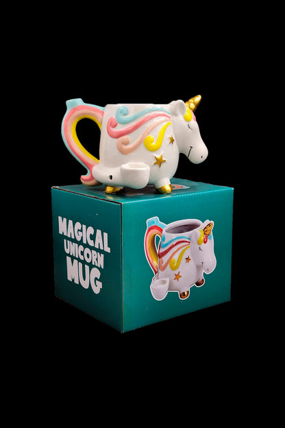 A whimsical unicorn-shaped ceramic mug sits atop its branded box, labeled “Magical Unicorn Mug,” with a colorful, playful design.