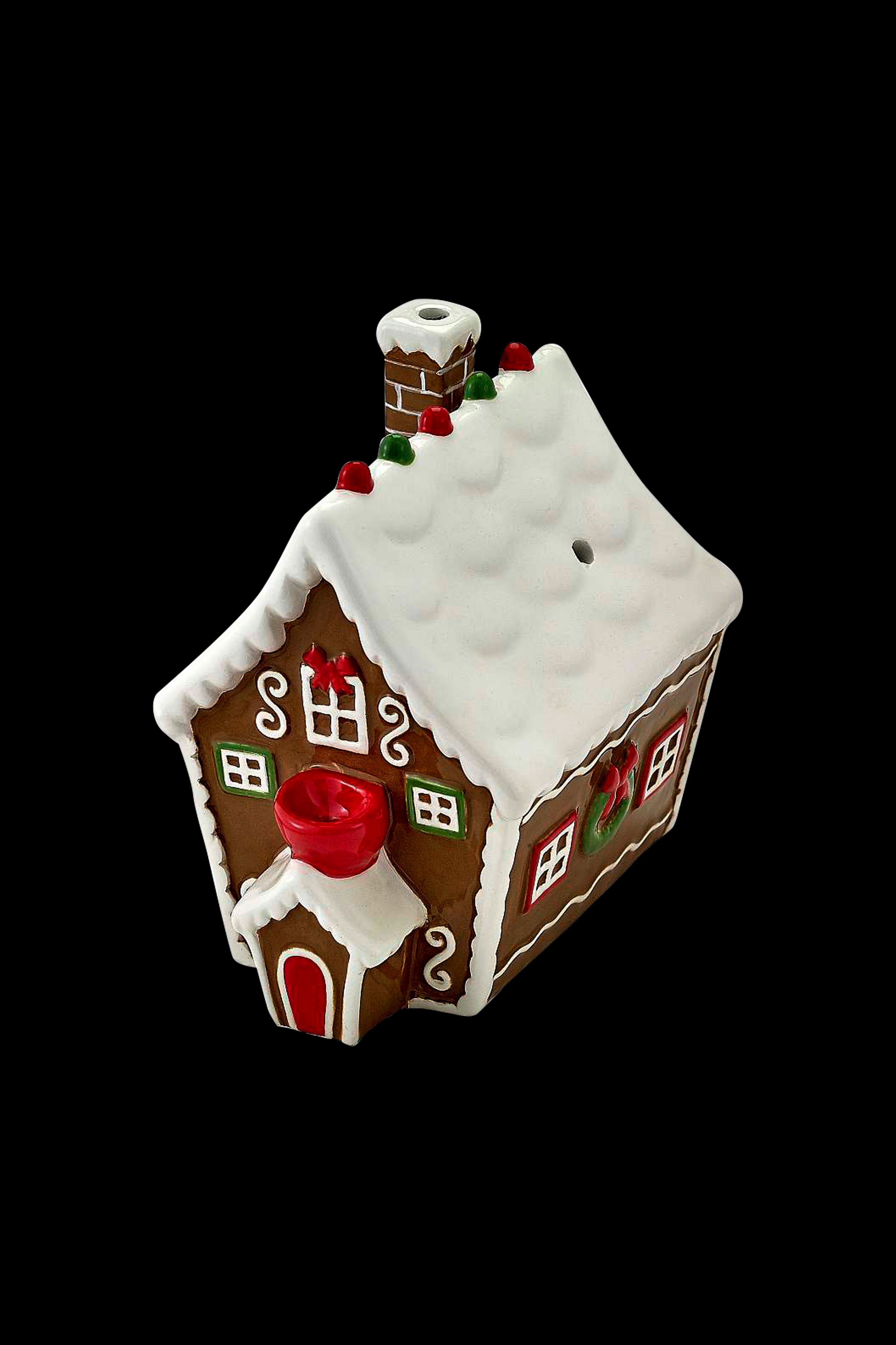 Gingerbread house-shaped ceramic piece with a bowl and mouthpiece, likely a cannabis smoking device.