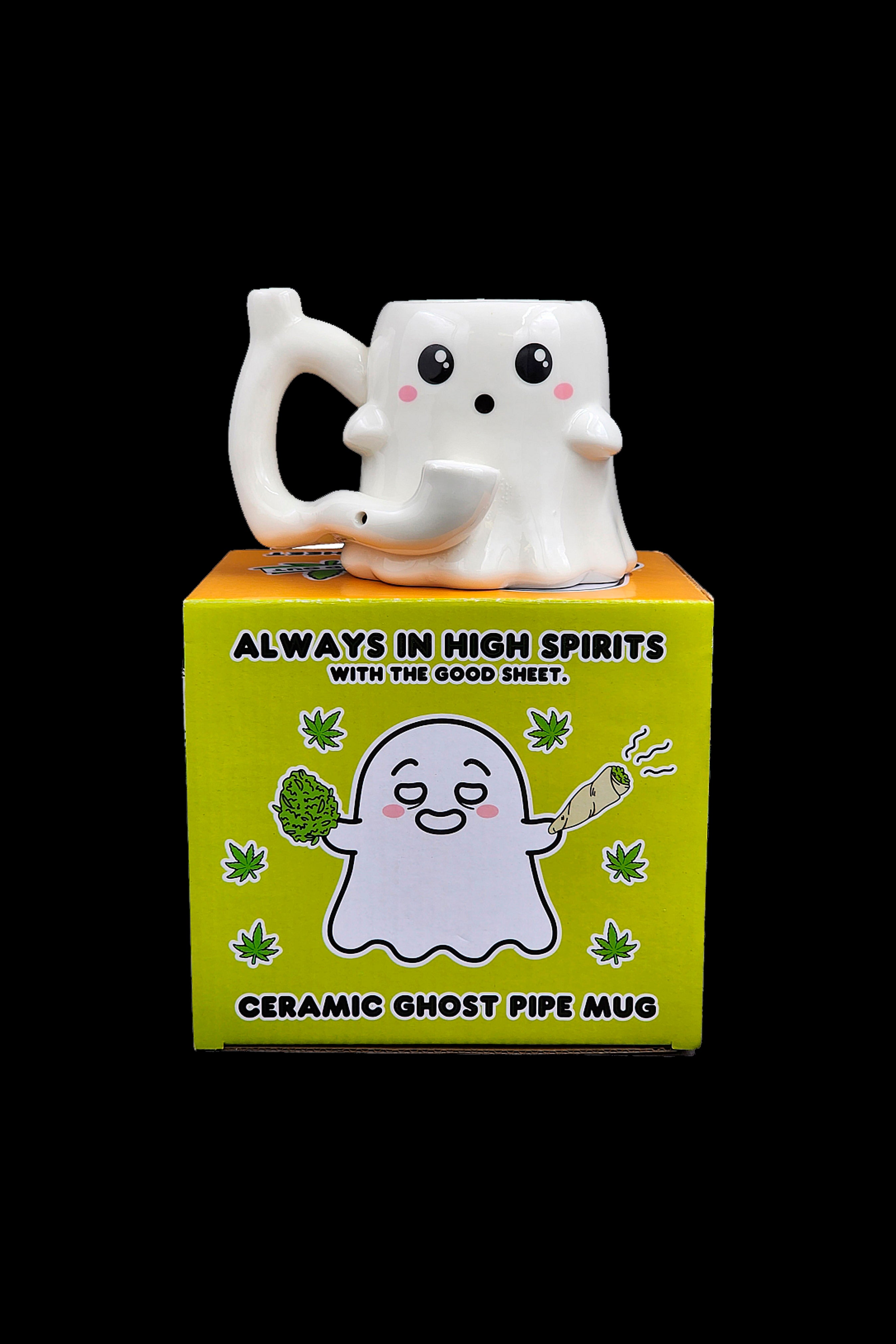 A ceramic mug shaped like a smiling ghost with the packaging displaying a cartoon ghost, cannabis buds, and the text "Always in High Spirits with the Good Sheet" and "Ceramic Ghost Pipe Mug."