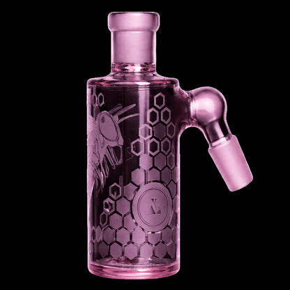 Close-up front view of the pink Milkyway Bee Hive Wet Ash Catcher showing its cylindrical body, honeycomb etching and angled male joint against a black background.
