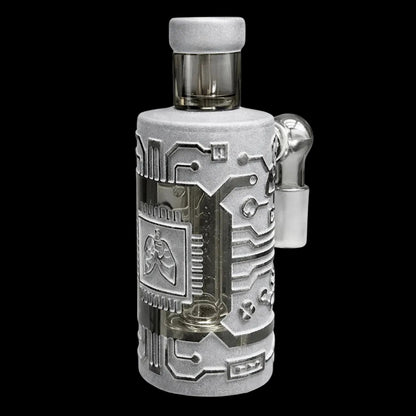 Close-up front view of the Milkyway Circuitboard Wet Ash Catcher showing a vertical smoked glass chamber wrapped in a textured silver circuitboard-style sleeve against a black background