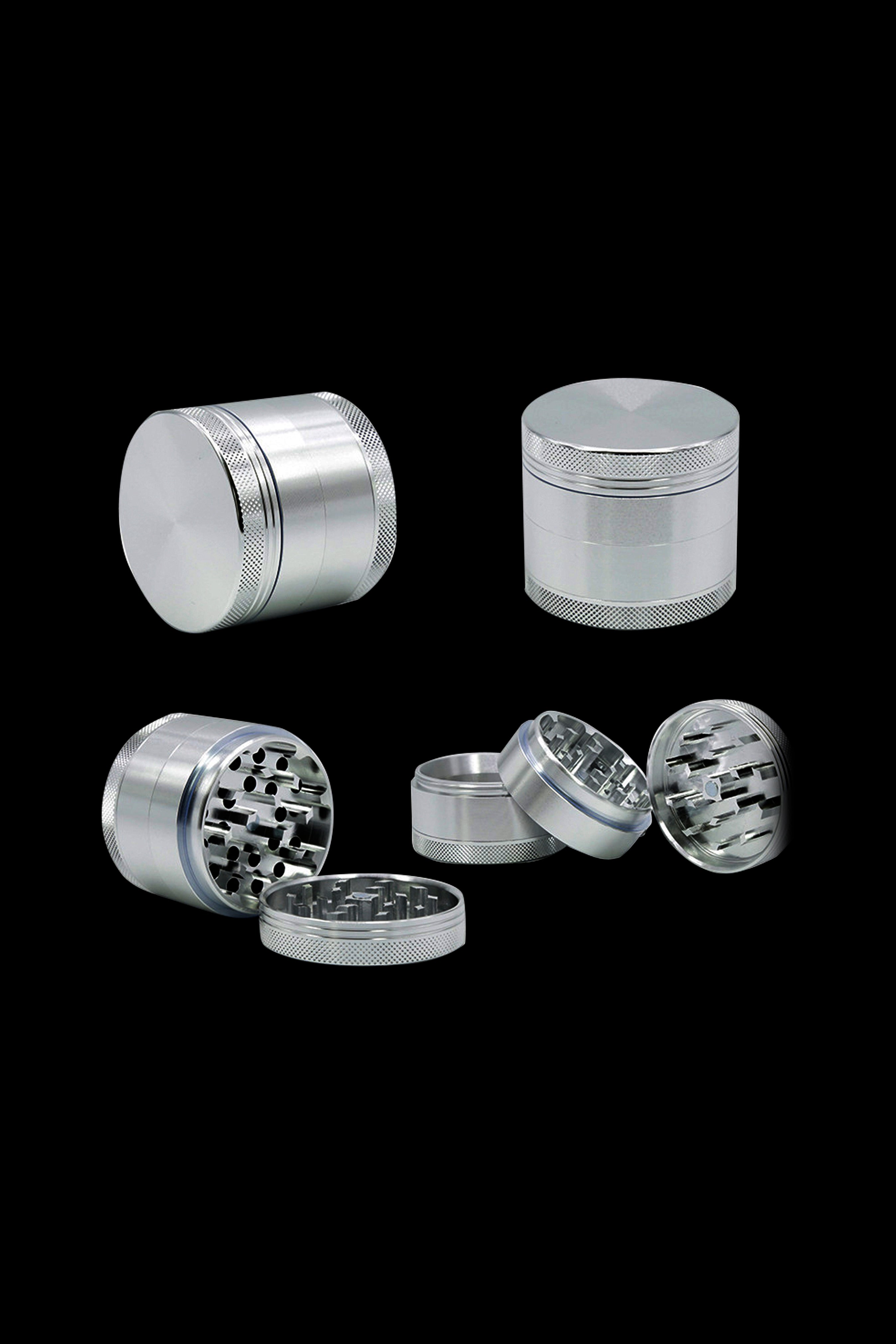 A disassembled view of the Cloud 8 Aluminum 4 Piece Grinder, showing its four separate metallic components against a dark background.