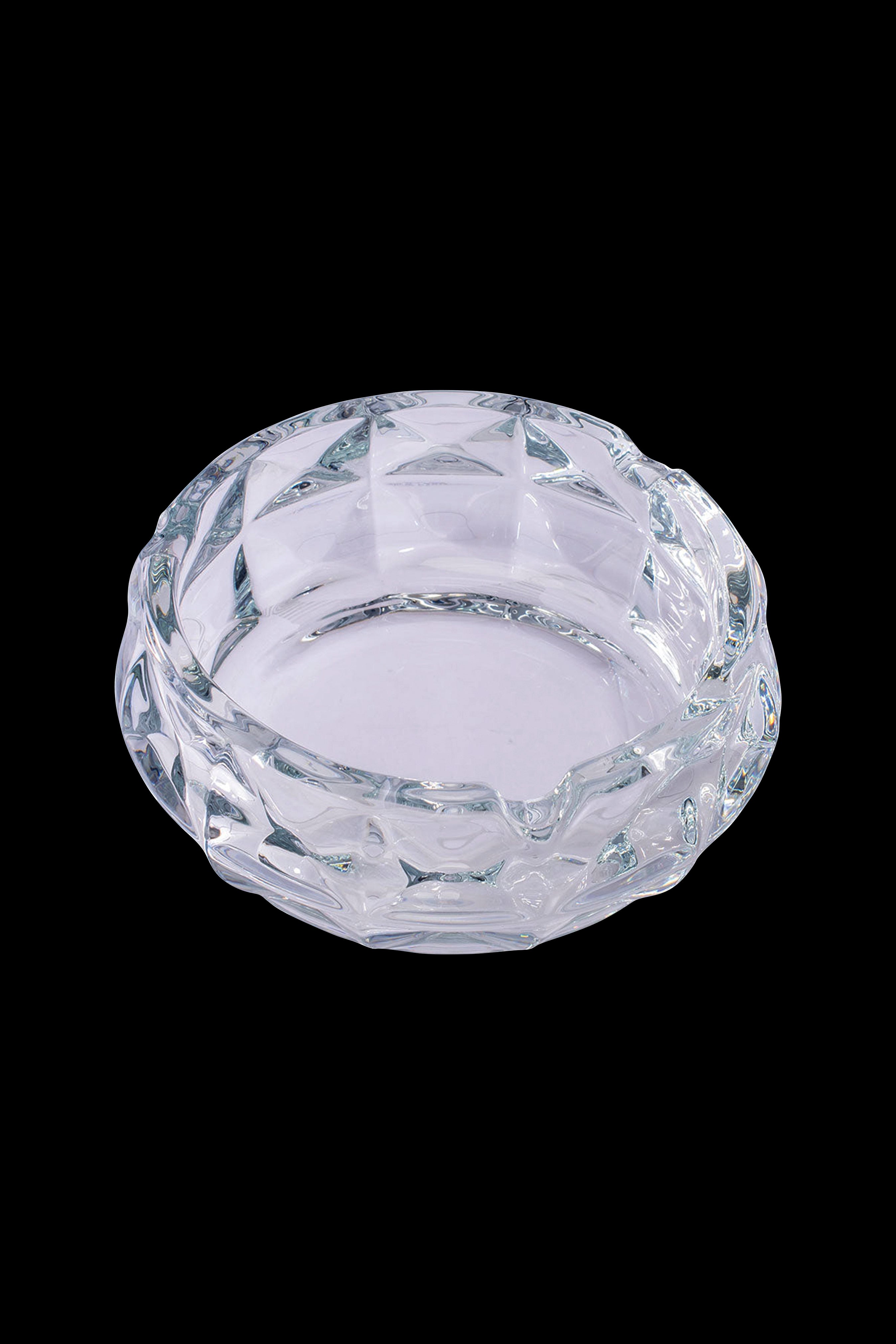 Clear glass ashtray with faceted design.