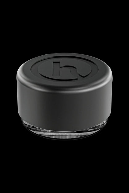 Black silicone cannabis concentrate container with clear base.