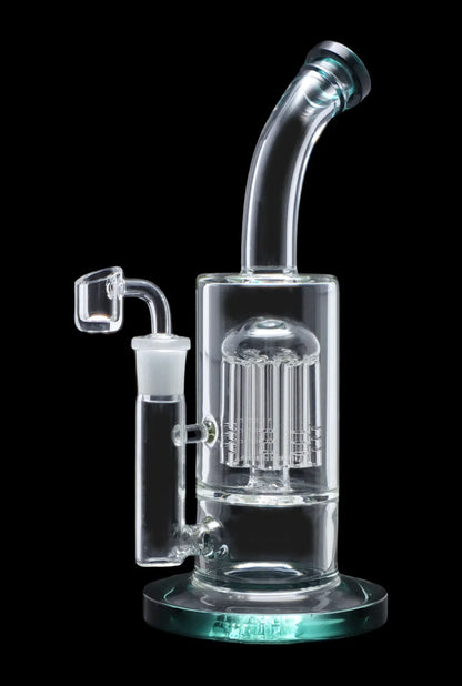 Clear glass dab rig with multiple diffusion perc chambers, featuring a quartz banger and accompanying glass attachment, isolated on a black background.