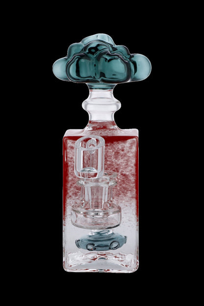 A clear glass water pipe (rig) with red liquid and intricate glasswork, topped with a blue glass cloud-shaped mouthpiece.