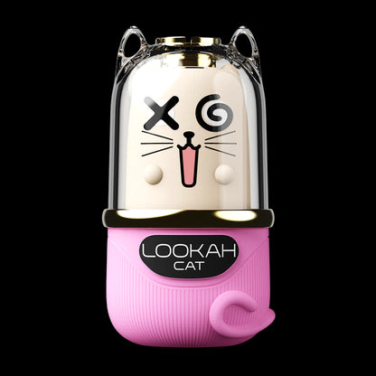 Close-up front view of a Barbie Pink Lookah Cat Vaporizer with a clear dome showing a cartoon cat face and gold trim against a black background