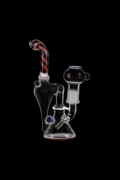 Clear glass water pipe (rig) with colorful accents, isolated on a black background.