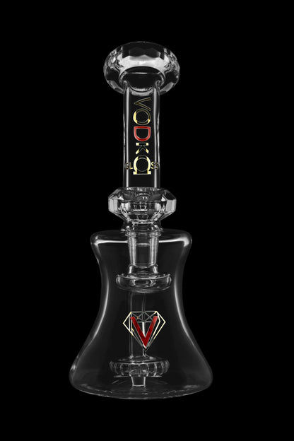 Clear glass dab rig with a geometric design and “VODKA GLASS” branding, isolated on a black background.
