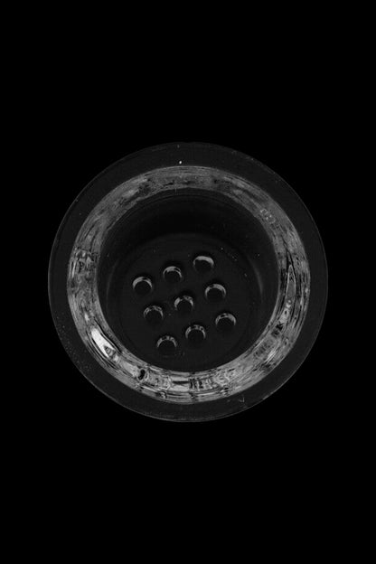 Overhead view of a glass pipe bowl filled with used cannabis.