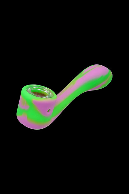 Neon pink and green silicone smoking pipe isolated on a black background.