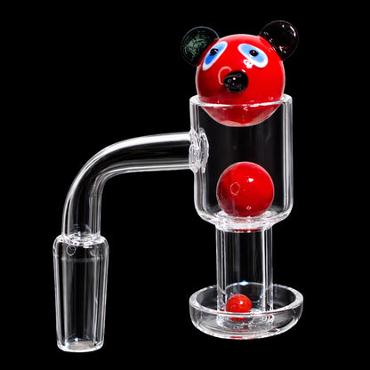 Close-up of the Smoke Cartel Bear Terp Slurper Banger Set - 14mm showing a red bear-head marble and two red spheres inside a clear glass banger against a black background