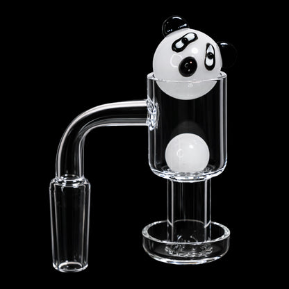Close-up, three-quarter view of the Smoke Cartel Bear Terp Slurper Banger Set - 14mm showing a white panda-themed terp slurper cap perched atop the clear glass banger against a black background.