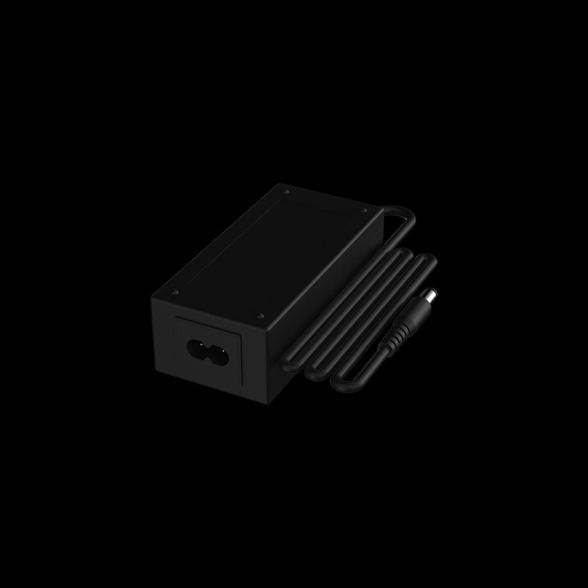 Angled close-up of the black Switch™ Charging Cable and Adapter showing the rectangular adapter block, coiled cable, and barrel connector against a pitch‑black background