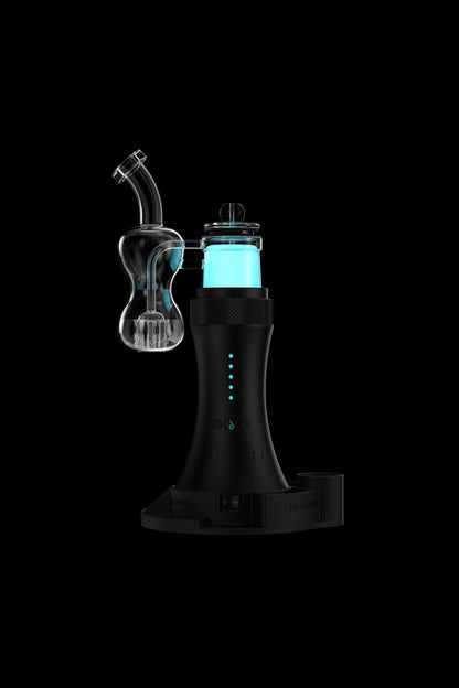 Black electronic dab rig with a glass bubbler attachment, illuminated with blue light, displayed on a charging base.