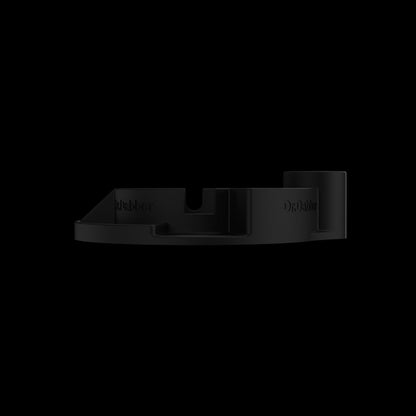 Low-angle close-up of the matte black Switch™ Silicone Base showing its stepped compartments against a black background.