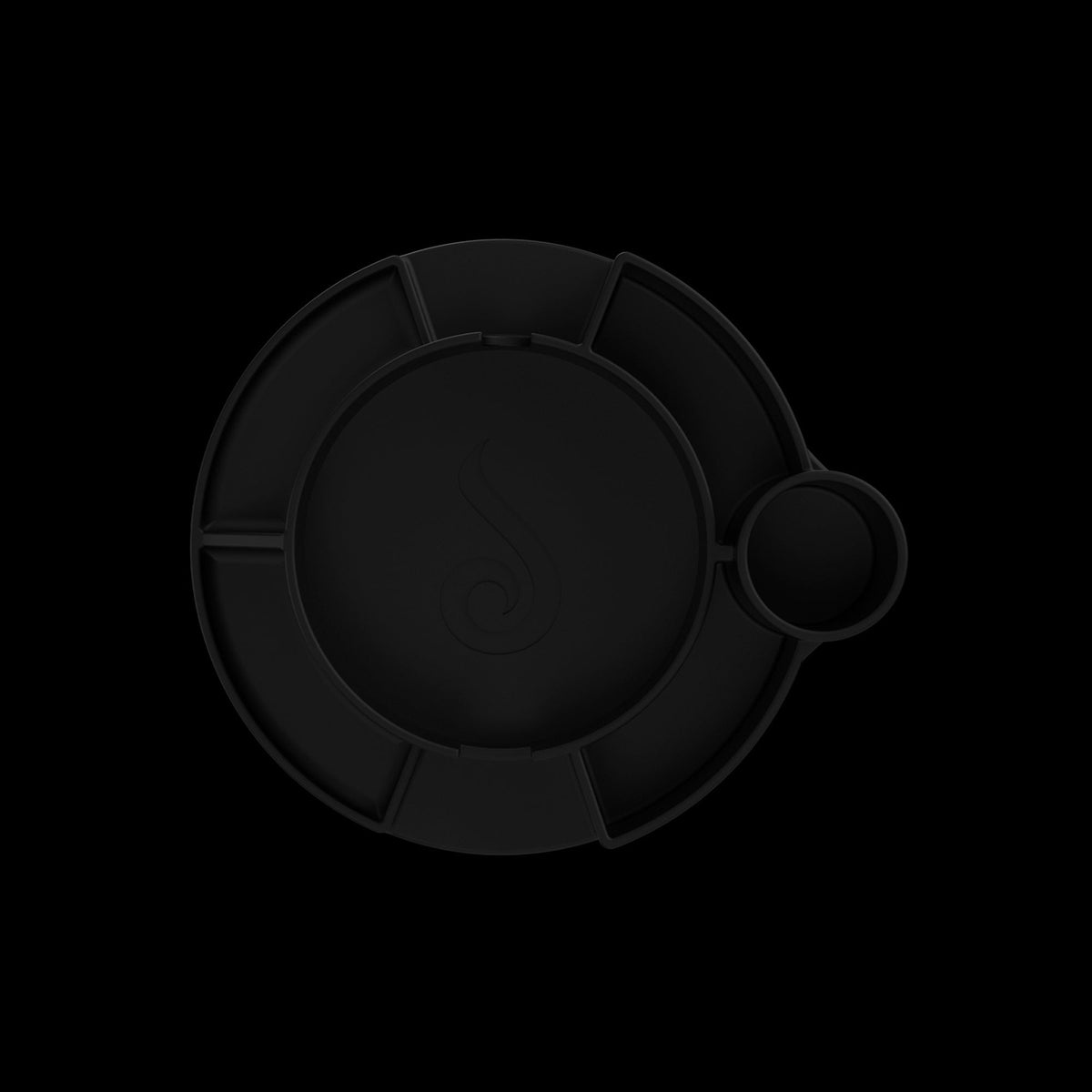 Top-down close-up of the black Switch™ Silicone Base showing its circular compartments and subtle raised rim against a dark background