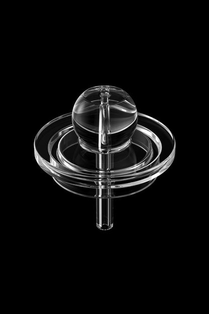 Clear glass cannabis oil rig bubbler against a black background.