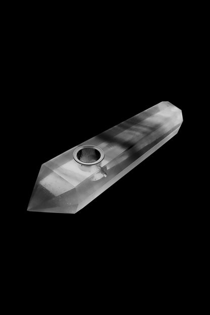 Clear glass pipe against a black background.