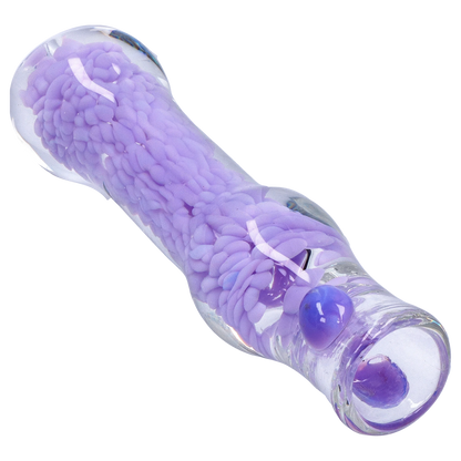 Angled close-up of the Smoke Cartel Frit Cone One Hitter - 3 in. showing a clear glass tube filled with textured lavender frit and glossy purple nubs.