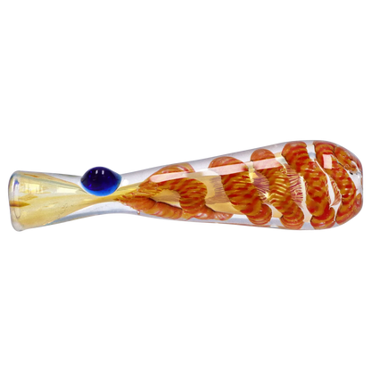Side view of a clear glass Smoke Cartel Piped and Fumed One Hitter - 3 in. with an internal twisted orange ribbon and a single raised blue glass bead.