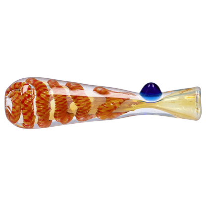 Side profile of the Smoke Cartel Piped and Fumed One Hitter - 3 in. showing orange spiral fuming inside clear glass and a small blue glass marble on top