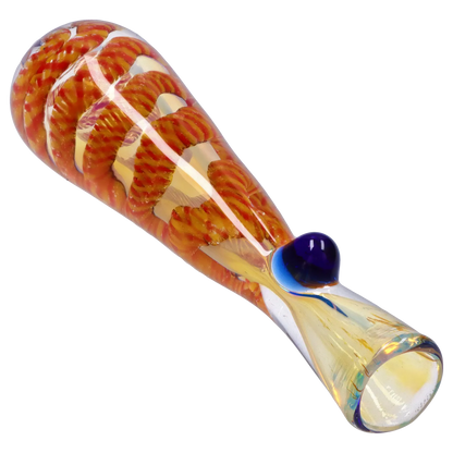 Angled close-up of the Smoke Cartel Piped and Fumed One Hitter - 3 in. showing orange spiral fuming inside clear glass with a blue glass knob.