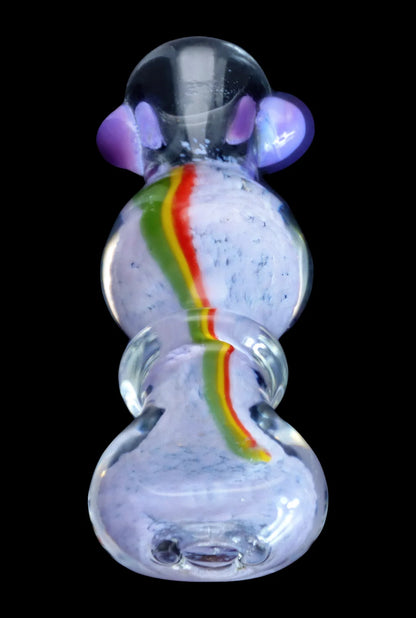Top-down view of the Smoke Cartel Frit Rasta One Hitter - 3 in. showing a clear glass piece with lavender frit texture and a central red-yellow-green rasta stripe.