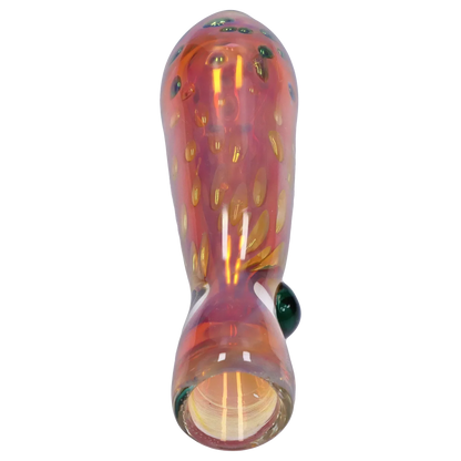 Top-down close-up of the Smoke Cartel Gold Dot One Hitter - 3 in. showing a glossy pinkish-orange glass body with raised gold dots and a green glass marble accent.