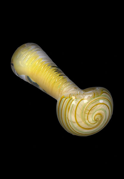 Angled close-up of the Smoke Cartel Engraved Fumed Spoon Pipe - 3 in., showing its yellow fumed glass with spiral bowl detail against a black background