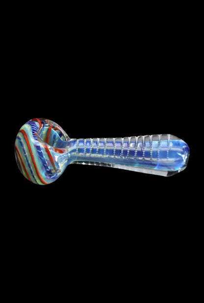 Side view of the Smoke Cartel Engraved Fumed Spoon Pipe - 3 in., showing a colorful swirled bowl and a clear, ridged glass stem against a black background