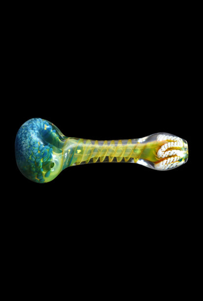 Horizontal studio shot of the Smoke Cartel Twisting Frit Spoon Pipe - 3 in. showing a blue-green rounded bowl, yellow twisted inner stem, and clear mouthpiece against black background