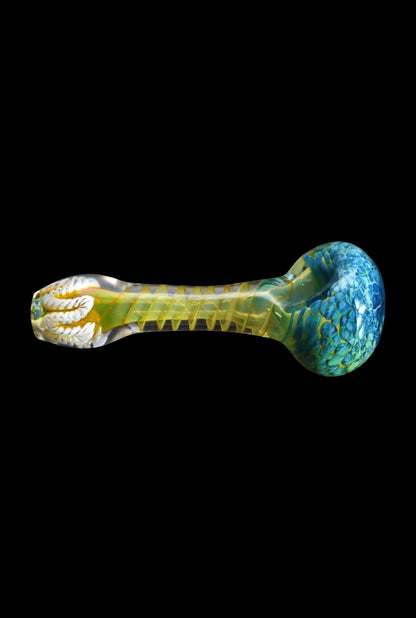 Side view of the Smoke Cartel Twisting Frit Spoon Pipe - 3 in., showing a blue-green patterned bowl and translucent yellow twisted stem against a black background