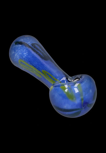 Angled close-up of the Smoke Cartel Color Frit Spoon Pipe - 3 in., showing blue glass with green ribbons and a glossy black background