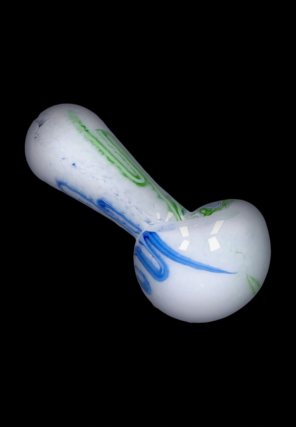 Angled top-down view of the Smoke Cartel Color Frit Spoon Pipe - 3 in., a white glass spoon pipe with green and blue frit swirls against a black background
