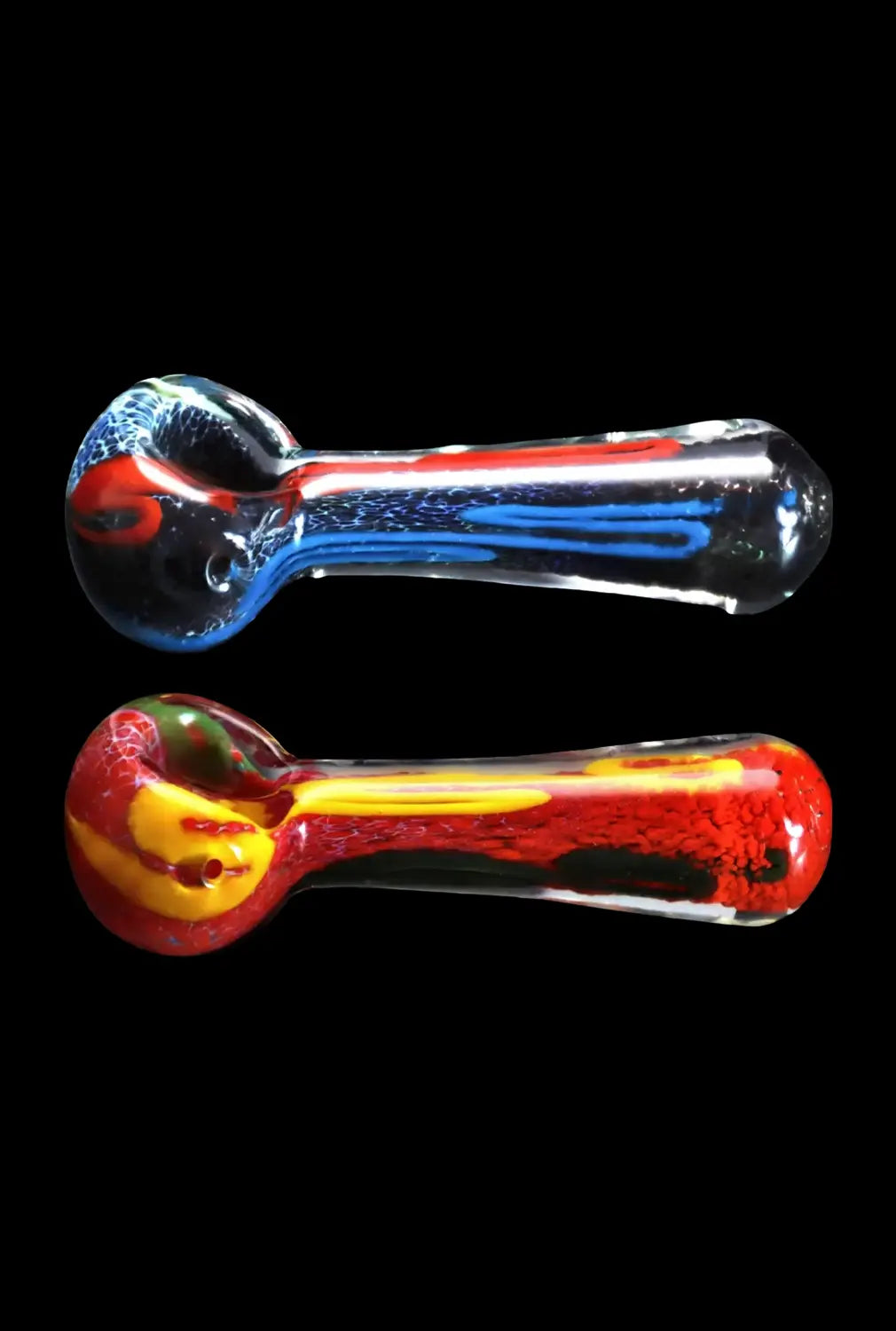 Side-by-side top-down view of two Smoke Cartel Color Frit Spoon Pipe - 3 in. glass spoons on a black background, one blue-striped and one red-yellow.