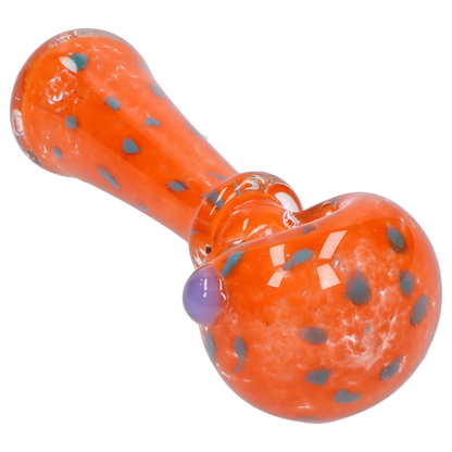 Angled close-up of the Smoke Cartel Frit with Twisted Mouthpiece Spoon Pipe - 4 in., showing its glossy orange glass with blue spots.