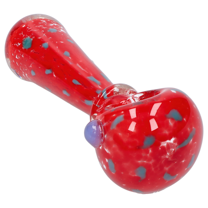 Angled close-up of the red Smoke Cartel Frit with Twisted Mouthpiece Spoon Pipe - 4 in., showing blue frit speckles and a glossy finish.