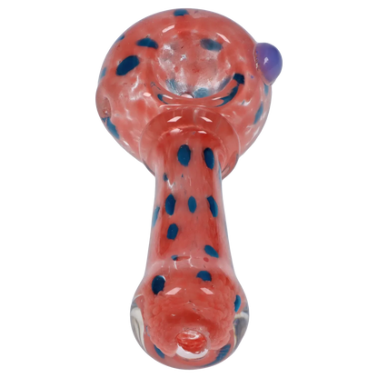 Top-down close-up of the Smoke Cartel Frit with Twisted Mouthpiece Spoon Pipe - 4 in., showing a red glass bowl and stem with scattered blue frit dots and a side purple knob.