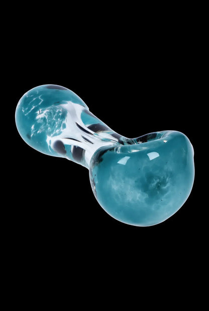 Angled close-up of the Smoke Cartel Colour Frit with Dots Spoon Pipe - 2.5 in. showing its turquoise glass bowl and swirled clear stem against a black background
