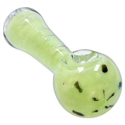 Close-up angled view of the Smoke Cartel Frit Marble Rim Pastel Spoon Pipe - 3.5 in., showing its pale green glass bowl with dark frit specks and glossy highlights