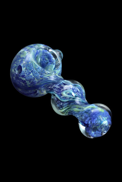 Angled close-up of the Smoke Cartel Fancy Frit Spoon Pipe - 3.5 in. showing marbled milky green and blue glass against black.