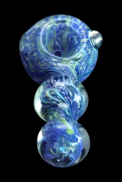 Top-down close-up of the Smoke Cartel Fancy Frit Spoon Pipe - 3.5 in. showing swirled milky blue and green glass textures against a black background