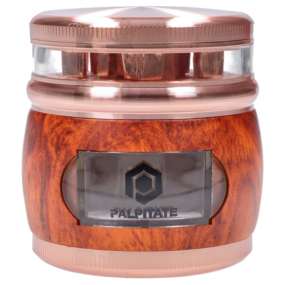 Close-up front view of the Smoke Cartel Glossy 3-Stage Grinder - 62mm showing its copper top, clear middle chamber, and wood-grain base.
